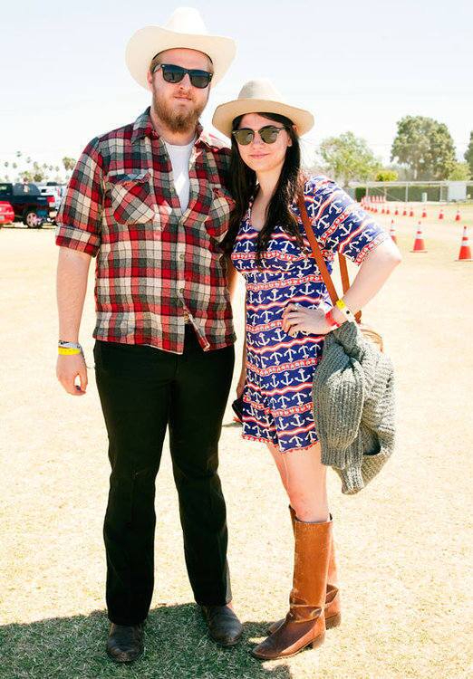 Chris Hudson, 20, left, from Missouri, wears Wrangler slacks and a Pendleton shirt. He says he was "comfortable for the day." Pearl Charles, 19, right, wears a vintage dress from Joshua Tree, Ray-Bans and a Stetson Hat. "We like to go with the old-school country look," said Charles.