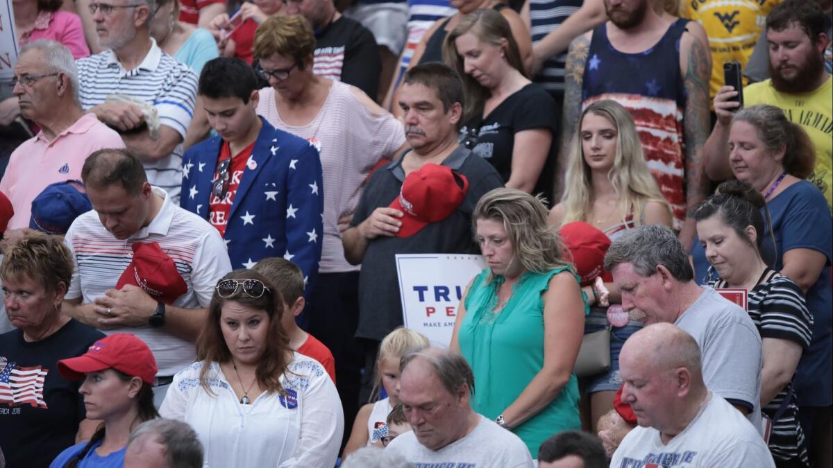 Supporters of President Trump pray during a rally in Lewis Center, Ohio, on Aug. 4.