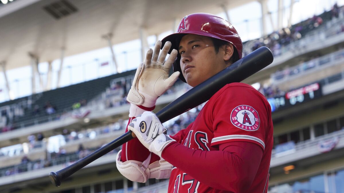 Los Angeles Angels pitcher Shohei Ohtani (17) waves to fans as he waits on deck.