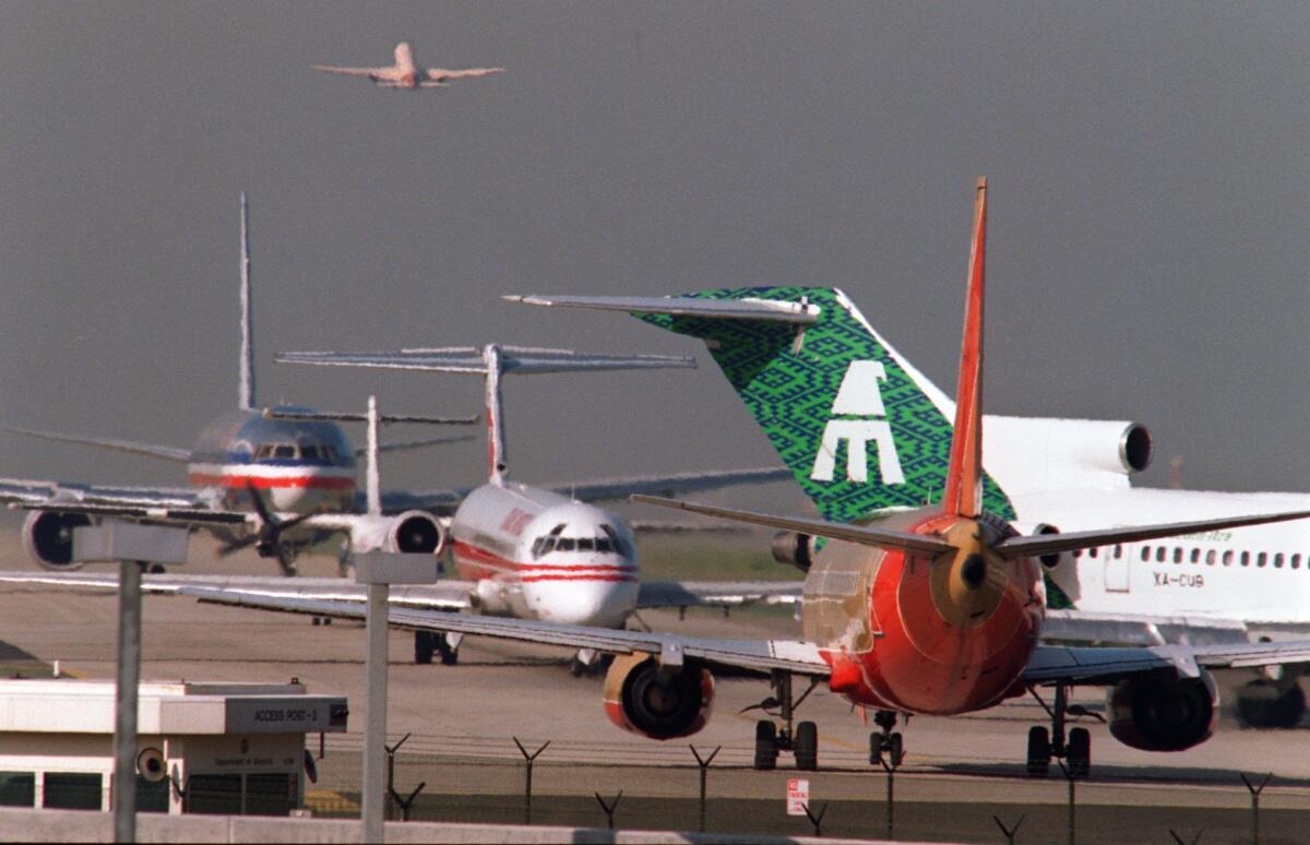 Planes line up on the north runway waiting to take off at Los Angeles International Airport. Airlines generate about 3% of carbon dioxide emissions in the U.S., according to an environmental group.