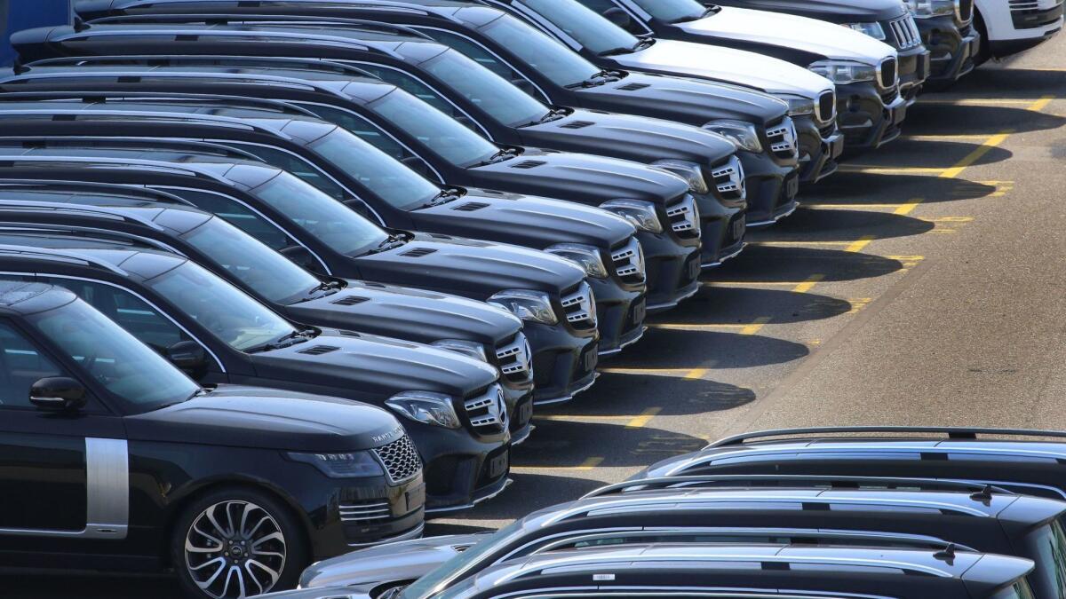 SUVs from Range Rover, Mercedes-Benz and BMW are lined up at the port of Bremerhaven in northern Germany. President Trump is threatening a 20% tariff on cars imported from Europe.