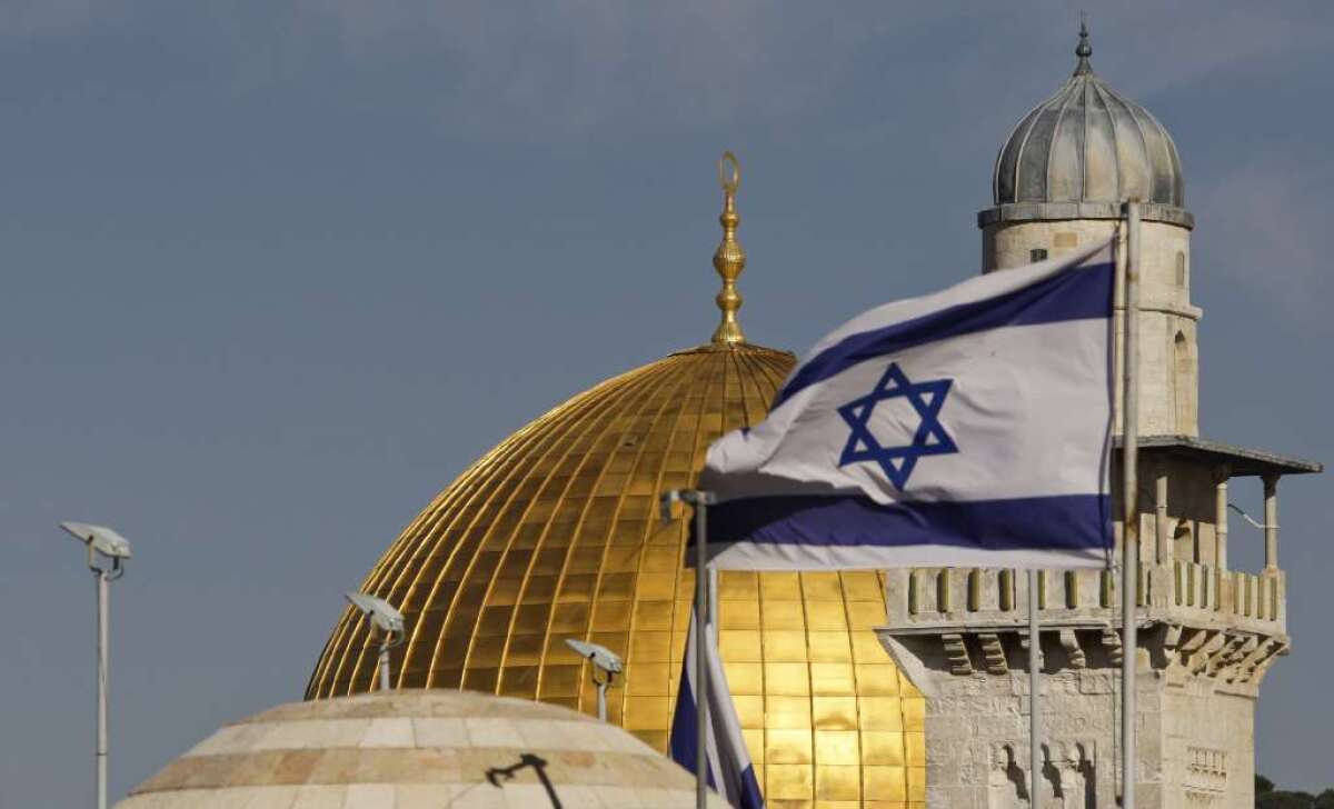 Will a two-state or one-state solution be the better option for Mideast peace? Above, an Israeli flag waves near the Dome of the Rock Mosque in Jerusalem.