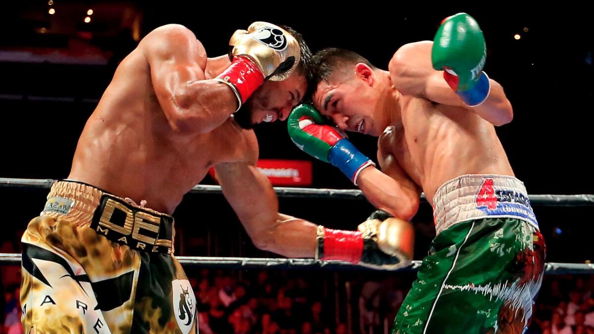 Leo Santa Cruz, right, and Abner Mares exchange punches during their featherweight fight on Aug. 29, 2015, at Staples Center.