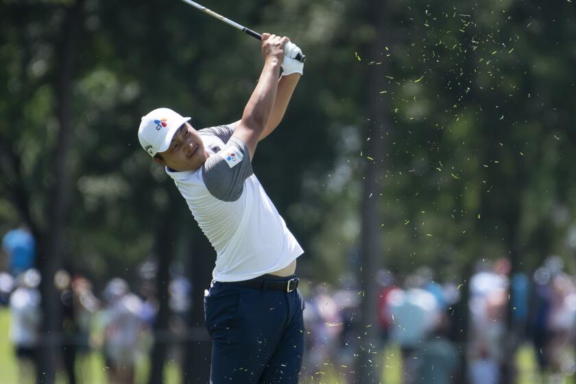 K.H. Lee, of South Korea, hits on the third hole during the fourth round of the AT&T Byron Nelson.