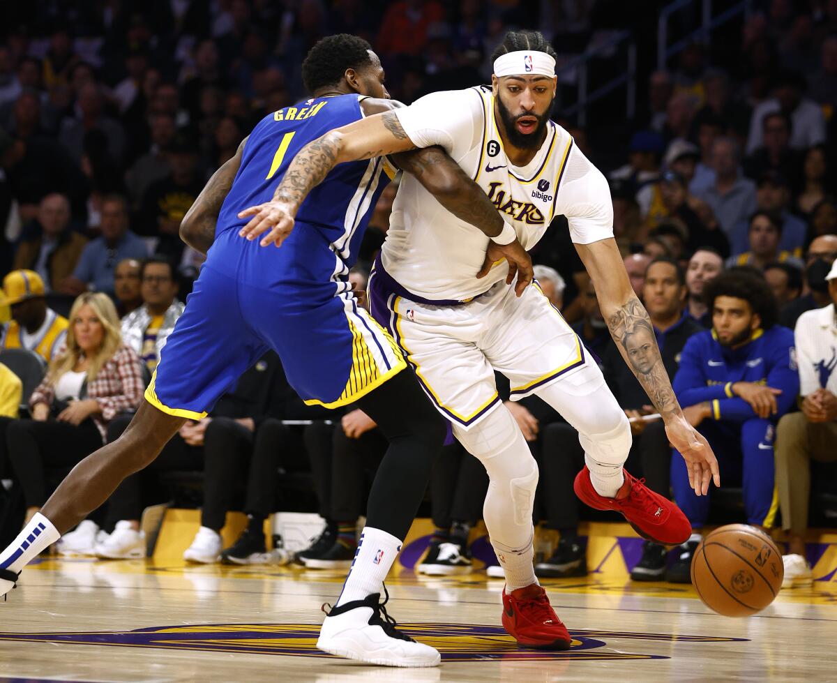 Lakers forward Anthony Davis dribbles around Warriors forward JaMychal Green during the first quarter of Game 3.