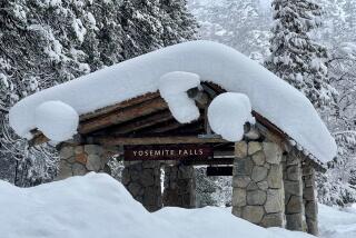 In this photo provided by the National Park Service, a structure at Yosemite Falls in Yosemite National Park, Calif., is covered in snow Tuesday, Feb. 28, 2023. Yosemite National Park, closed since Saturday because of heavy, blinding snow, postponed its planned Thursday, March 2, 2023, reopening indefinitely. (National Park Service via AP)