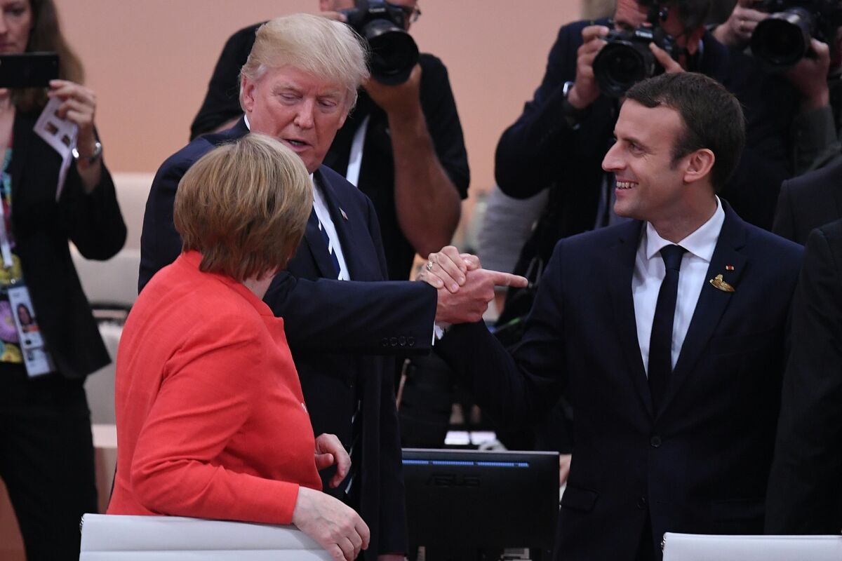 Angela Merkel, Emmanuel Macron and Donald Trump at a Group of 20 summit in 2017. How can we solve global problems if nations hide behind defensive walls?