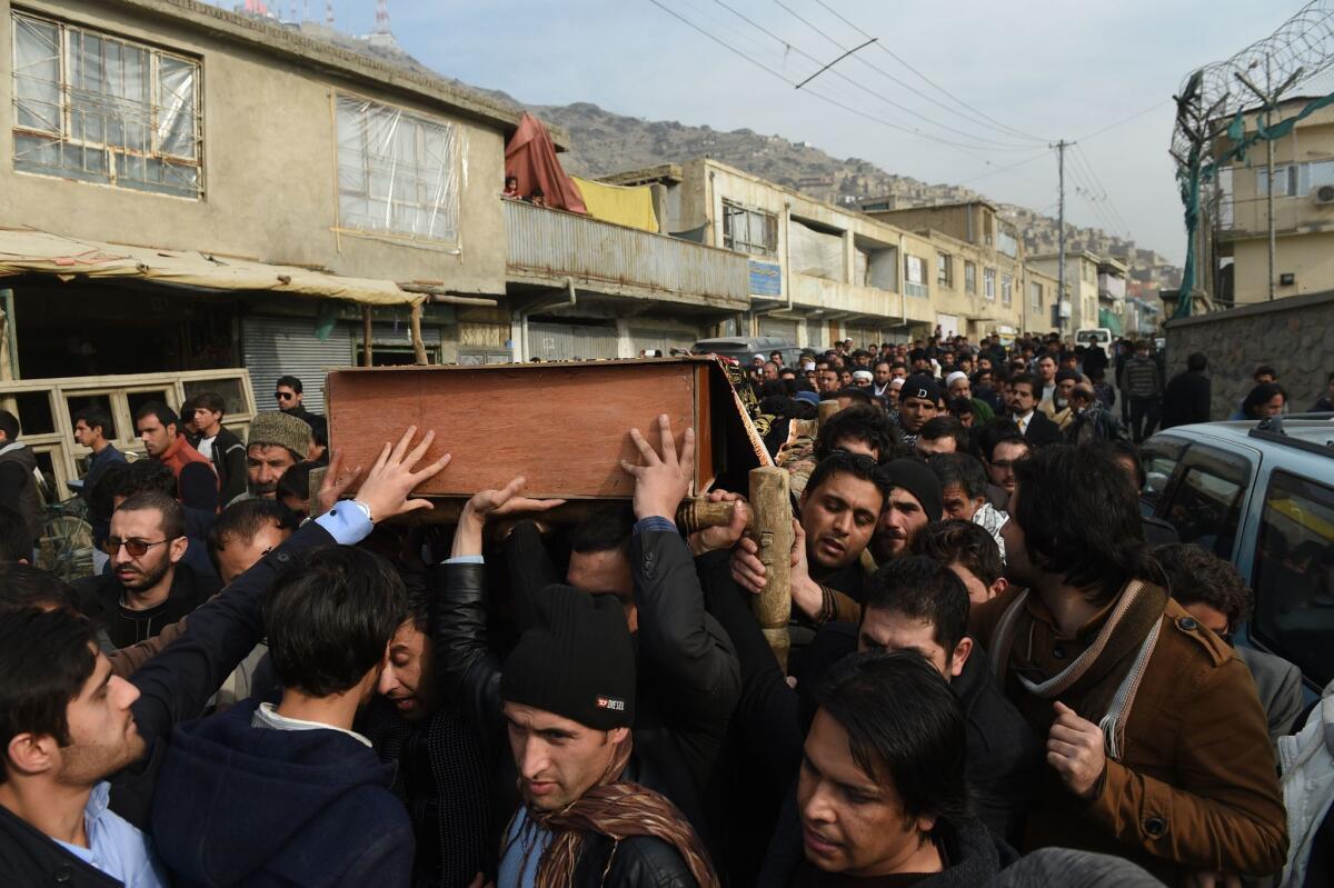 Friends and family carry the coffin of Afghan journalist Zubair Hatami during his funeral in Kabul, Afghanistan, on Sunday. A cameraman for the local Mitra TV station, Hatami died of wounds sustained in a bomb blast at the French Cultural Center.