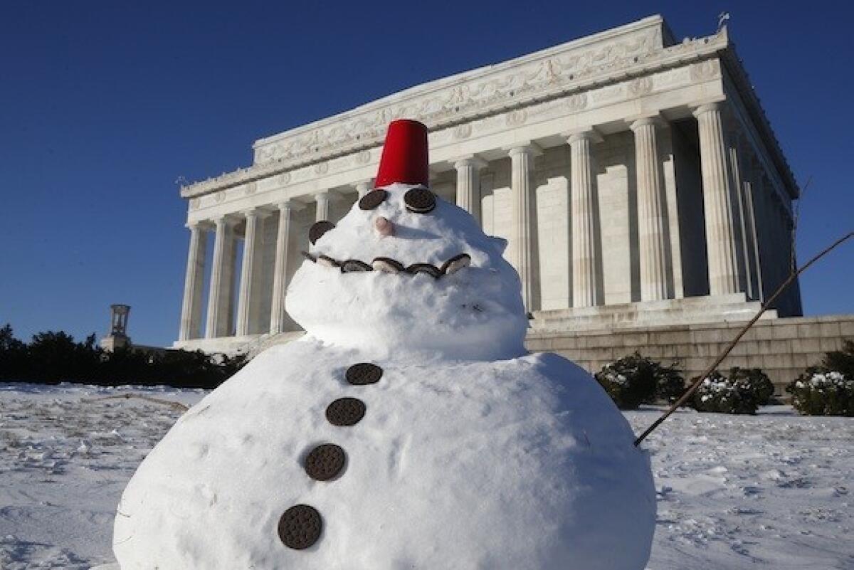 A snowman made with cookies and a red plastic cup sits in front of the Lincoln Memorial in Washington, D.C., on Wednesday.