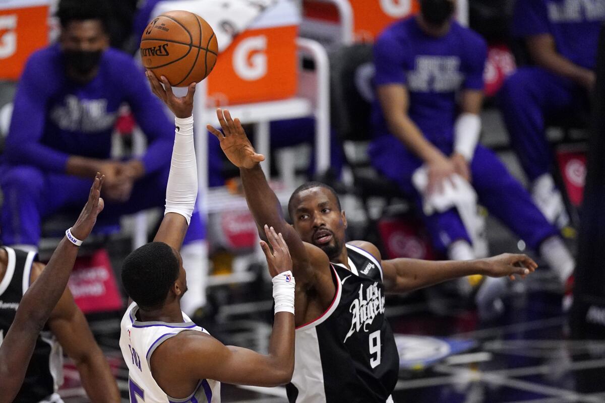 Serge Ibaka reaches to block a shot by De'Aaron Fox.