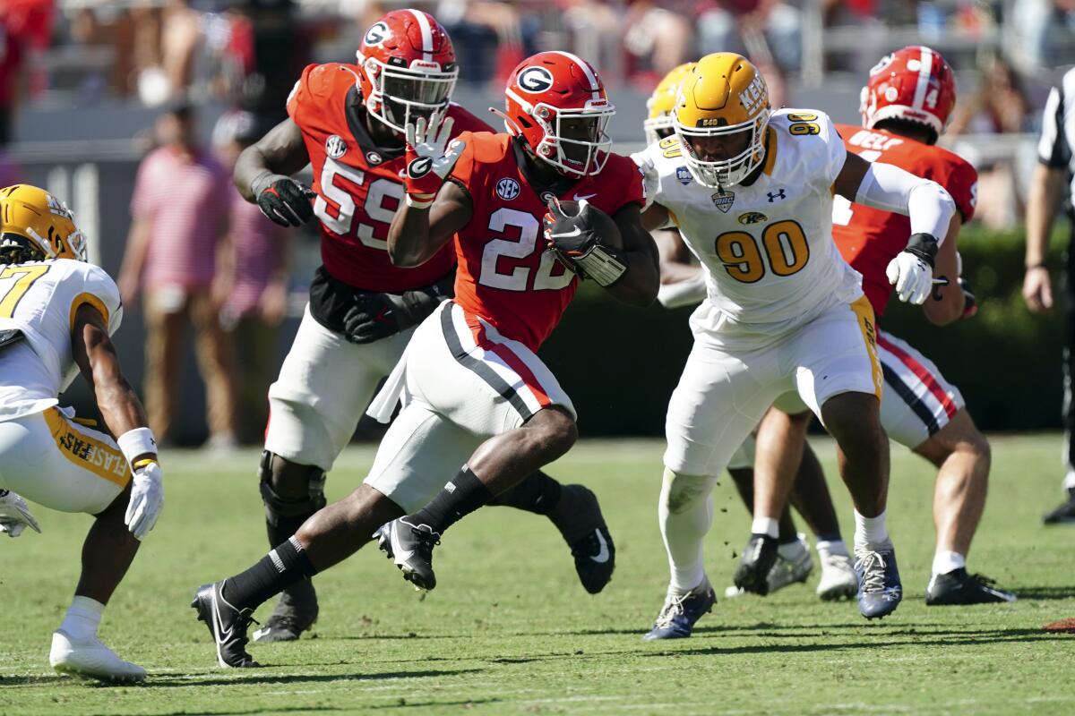 Georgia running back Branson Robinson (22) runs past Kent State defensive lineman Stephen Daley (90) in the first half of an NCAA college football game Saturday, Sept. 24, 2022, in Athens, Ga. (AP Photo/John Bazemore)