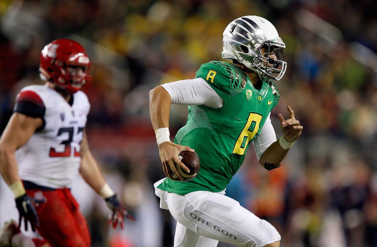 Ducks quarterback Marcus Mariota breaks into the secondary for a big gain against the Wildcats in the first half of the Pac-12 Conference championship game.