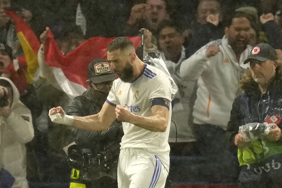 Real Madrid's Karim Benzema celebrates after scoring his side's first goal during a Champions League first-leg quarterfinal soccer match between Chelsea and Real Madrid at Stamford Bridge stadium in London, Wednesday, April 6, 2022. (AP Photo/Kirsty Wigglesworth)