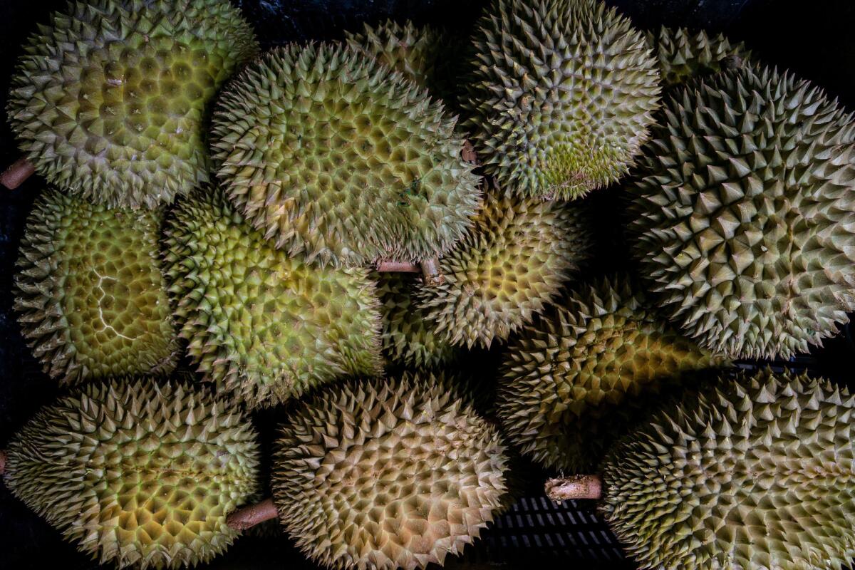 Durian fruit in baskets at a roadside stall. (Suzanne Lee / For The Times)