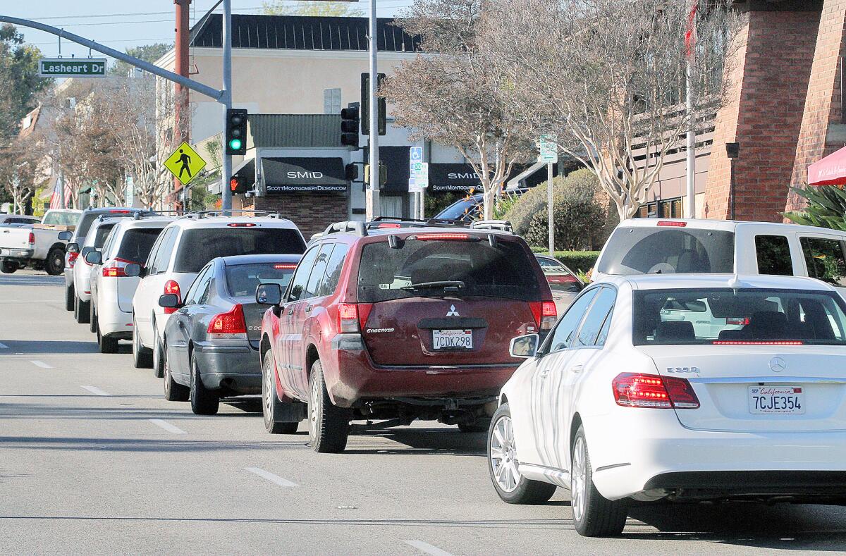 A lane of cars is stopped in front of La Cañada Flintridge City Hall on Foothill Boulevard on Tuesday, Jan. 26, 2016. More than half of all greenhouse gas emissions in 2014 came from cars driving inside city limits, according to a climate report.