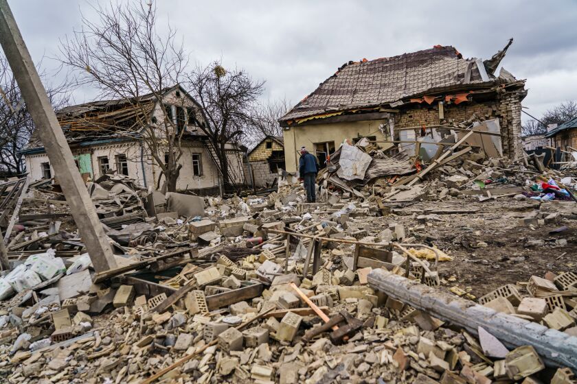 MARKHALIVKA, UKRAINE -- MARCH 5, 2022: Local residents help clear the rubble of a home that was destroyed by a suspected Russian airstrike which killed at least six people in Markhalivka, Ukraine, Saturday, March 5, 2022. (MARCUS YAM / LOS ANGELES TIMES)