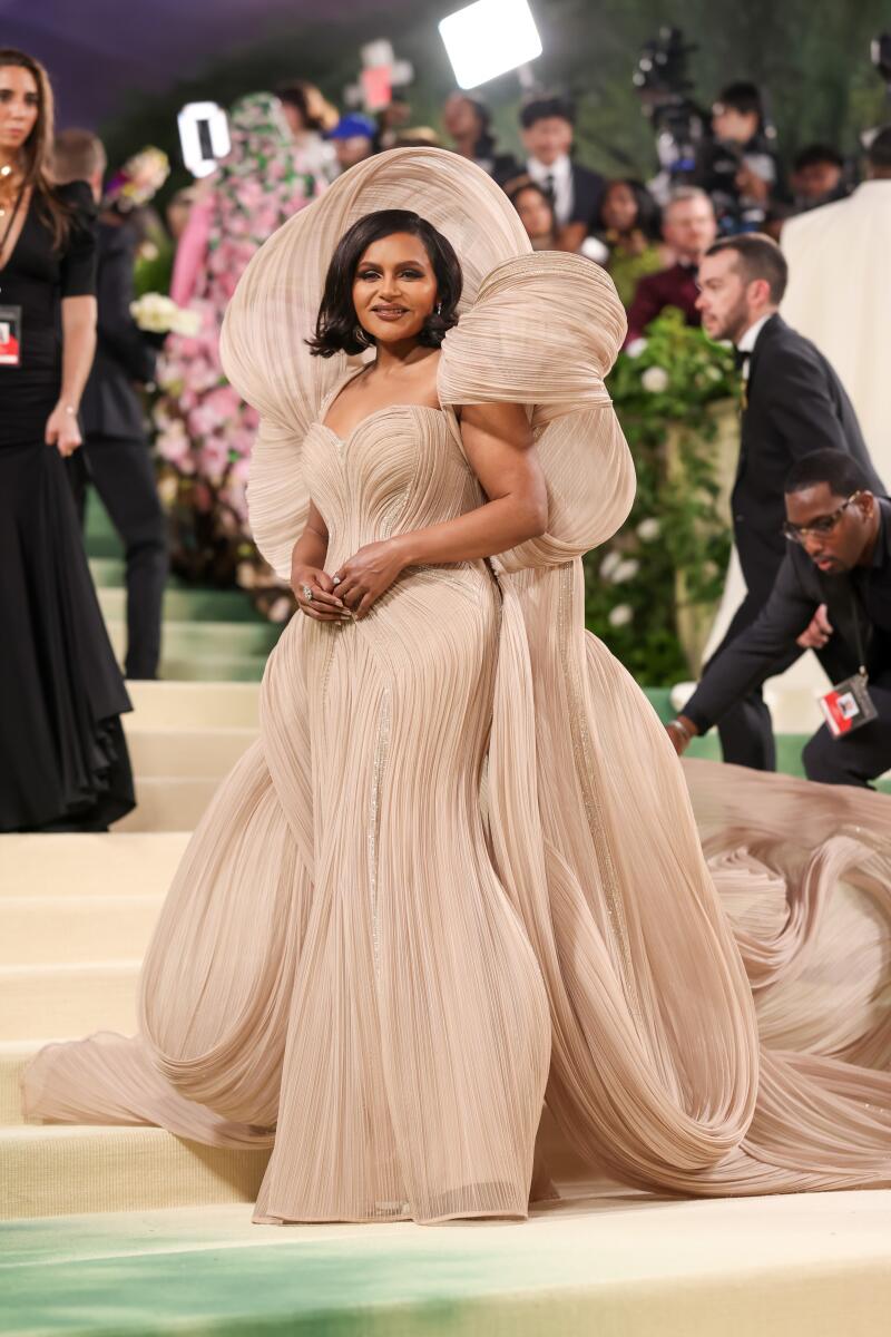 Mindy Kaling’s tawny Gaurav Gupta gown with a gazillion gathers and a ginormous back bow makes her look like the fairy godmother we always knew she could be.