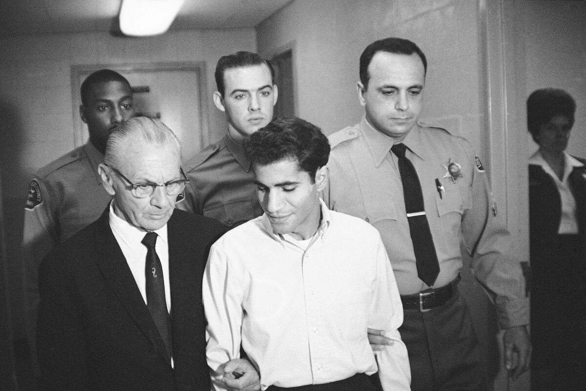  June 28, 1968, Sirhan Bishara Sirhan is escorted by his attorney, Russell E. Parsons from Los Angeles county jail.