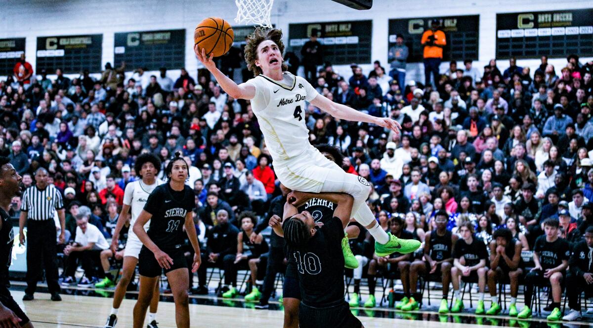 Notre Dame forward Dusty Stromer elevates over a Sierra Canyon defender for a layup.