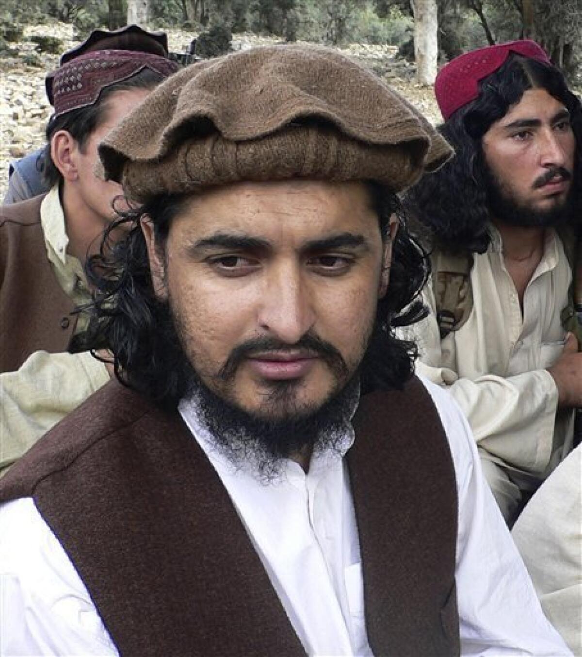 FILE - In this Oct. 4, 2009 file photo, Pakistani Taliban chief Hakimullah Mehsud sits during his meeting with media in Sararogha of Pakistani tribal area of South Waziristan along the Afghanistan border. Two new videos from the Pakistani Taliban appear to show their leader Hakimullah Mehsud alive and refuting earlier American and Pakistani claims that he was killed in a U.S. missile strike earlier this year, monitoring groups said Monday, May 3, 2010. The videos featuring Mehsud surfaced over the weekend after an attempted car bombing in New York City, and were the strongest evidence yet that he had survived the January missile attack. (AP Photo/Ishtiaq Mehsud, File)