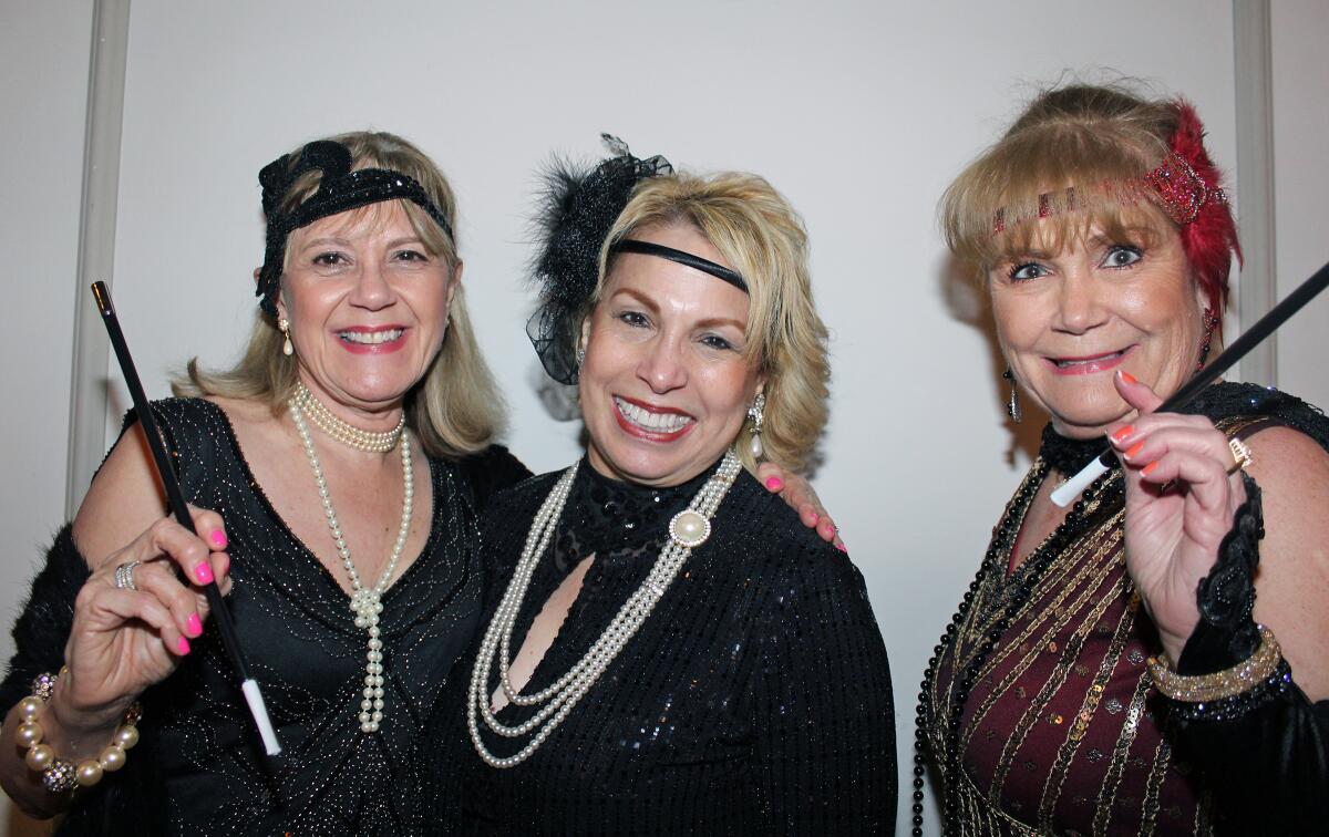 All dressed up as roaring '20s flappers are, from left, Monica Sierra, Miryam Finkelberg and guest Mercy Velasquez.