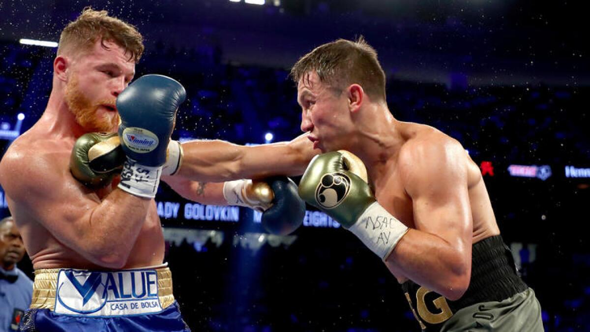 Gennady Golovkin lands a straight right to the chest of Canelo Alvarez.
