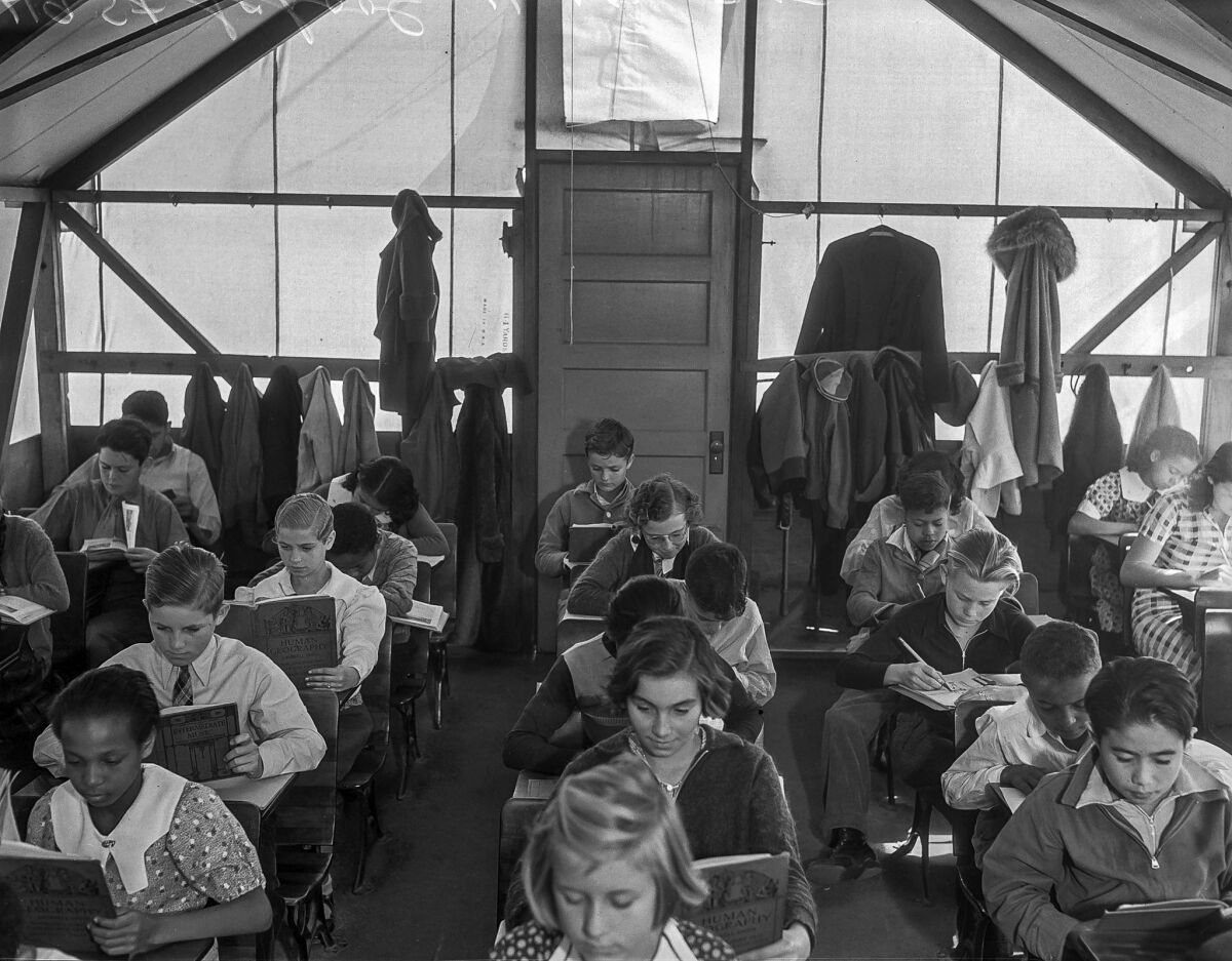 Nov. 17, 1935: Children read inside a canvas tent at 49th Street School.