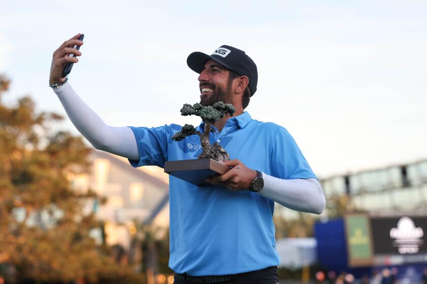 San Diego, CA - January 27: Matthieu Pavon takes a selfie with the trophy after winning the Farmers Insurance Open at Torrey Pines South Course on Saturday, Jan. 27, 2024 in San Diego, CA. (Meg McLaughlin / The San Diego Union-Tribune)