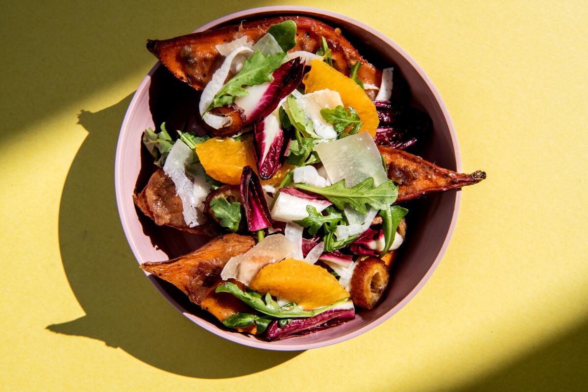 Cold crisp salad tops hot sweet potatoes.