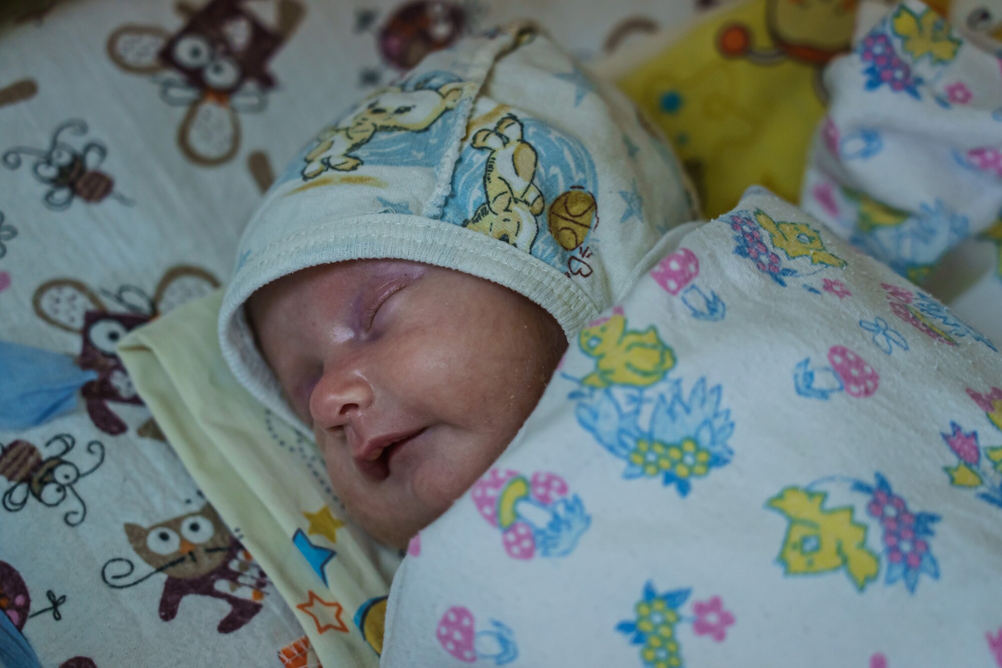 A newborn gets rest in a makeshift underground maternity ward.