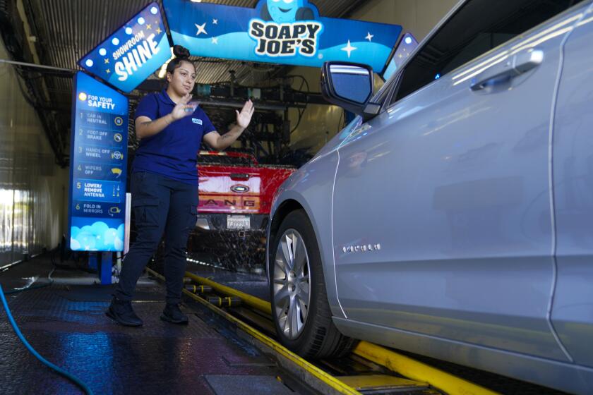National City, CA - October 25: On Tuesday, Oct. 25, 2022 in National City, CA., Soapy Joe’s Manager, Pricilla Piekunka-Madrigal at the entrance to the car wash. Madrigal has worked for the company for the past three-years and is currently the onsite manager for the National City location. (Nelvin C. Cepeda / The San Diego Union-Tribune)