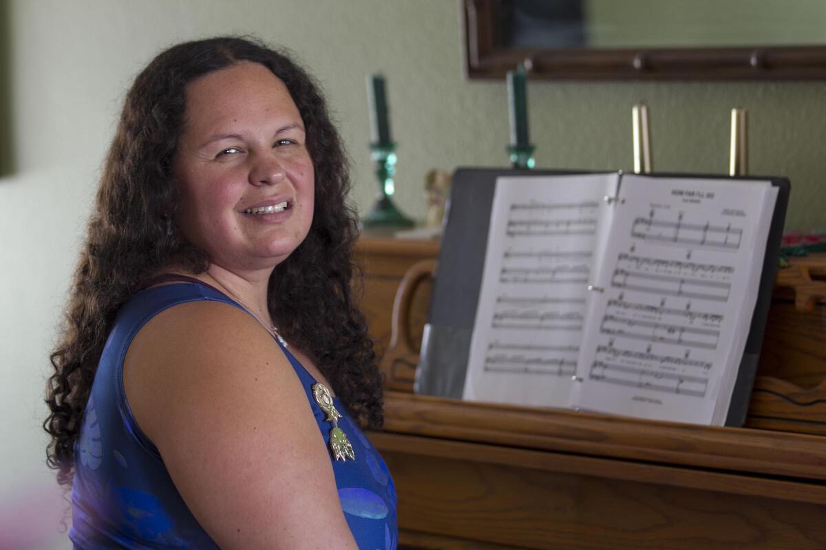 Katrina Aguilar, a graduate of the Boston Conservatory, has written a musical stage show featuring 16 songs from animated Disney movies that tells the sometimes difficult story of her life's journey with autism. She was photographed in her home in Rancho Peñasquitos on Thursday, Sept. 5th.