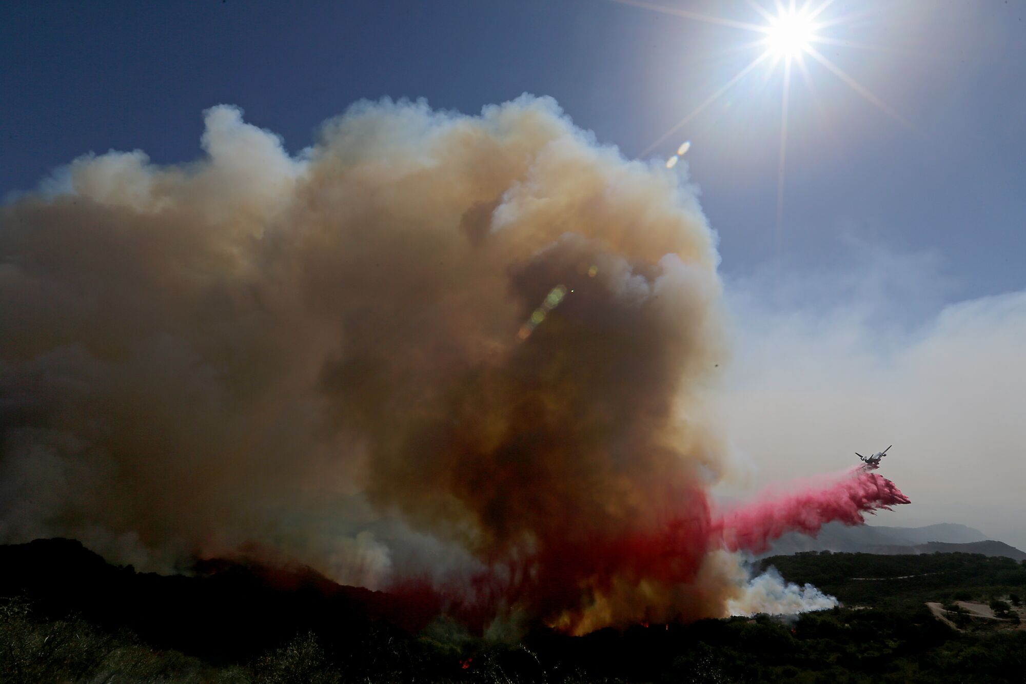 Smoke from the Alisal fire near Goleta as an aircraft drops fire retardant Wednesday.