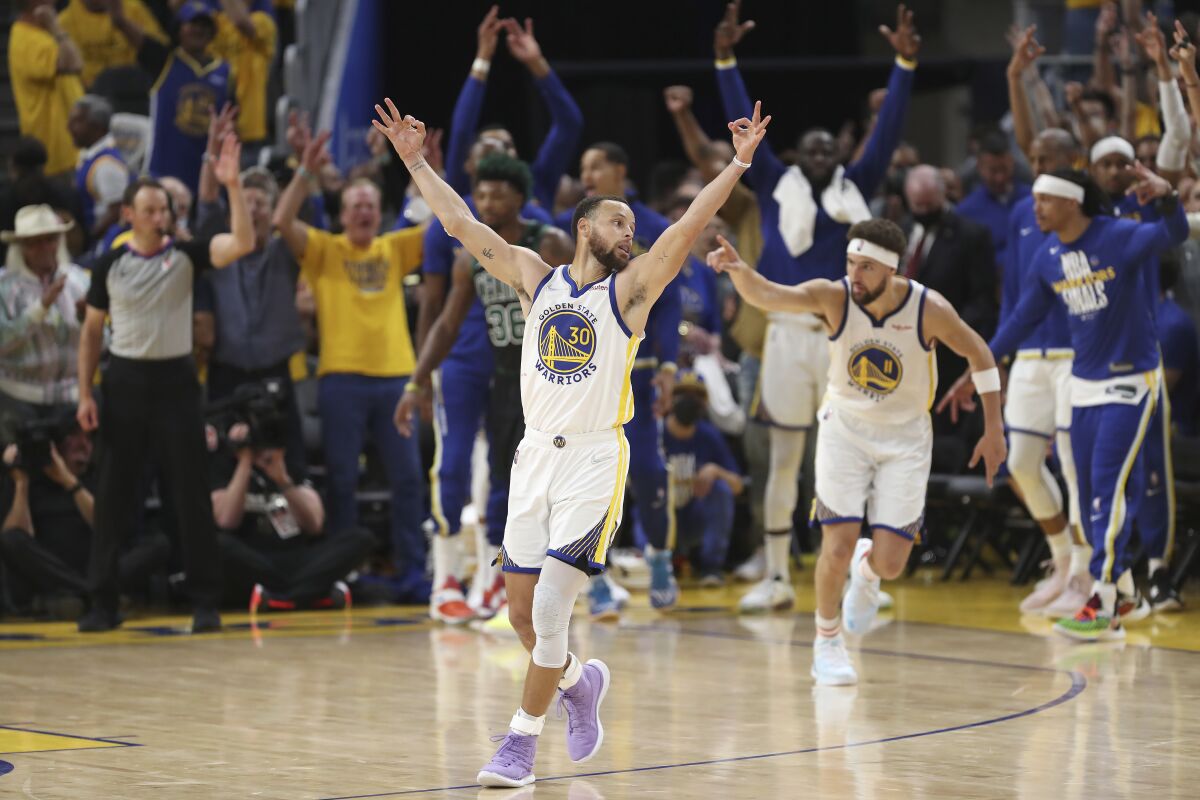 Golden State Warriors guard Stephen Curry (30) celebrates after guard Klay Thompson, right, shot a 3-point basket during the second half of Game 5 of basketball's NBA Finals against the Boston Celtics in San Francisco, Monday, June 13, 2022. (AP Photo/Jed Jacobsohn)