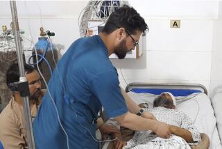 A wounded man receives treatment in a hospital, after a bombing at a mosque in the town of Imam Saheb, in Kunduz Province in north of Kabul, Afghanistan, Friday, April 22, 2022. A Taliban official says a bombing at a mosque and religious school in northern Afghanistan on Friday killed at least 33 people, including students of a religious school. (AP Photo/Abdullah Sahil)