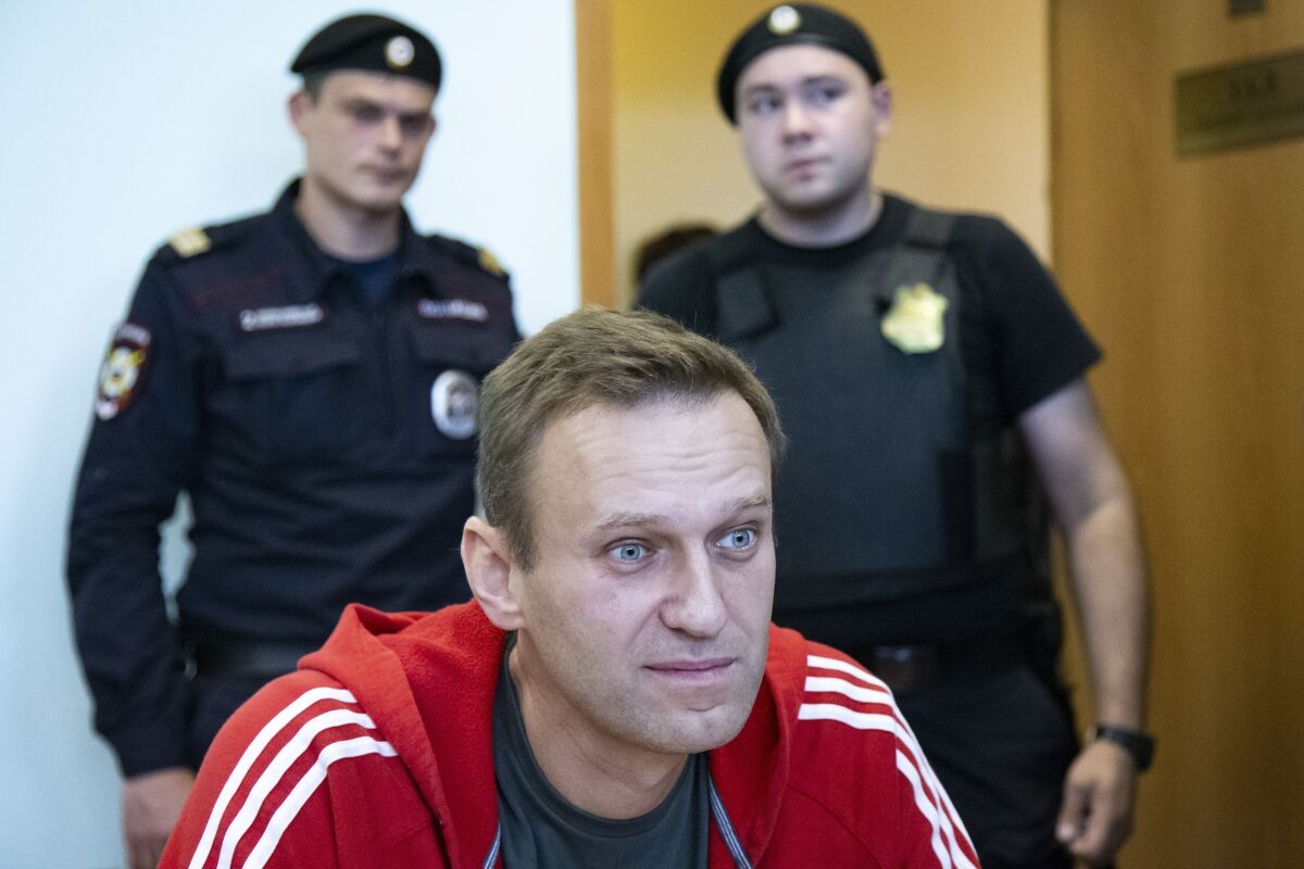 FILE- In this file photo taken on Thursday, Aug. 22, 2019, Russian opposition leader Alexei Navalny speaks to the media prior to a court session in Moscow, Russia. The German government on Friday criticized an announcement by Russia's foreign minister that Moscow has imposed sanctions against German and French officials in response to EU measures taken over the poisoning of Russian opposition leader Alexei Navalny. (AP Photo/Alexander Zemlianichenko, File)