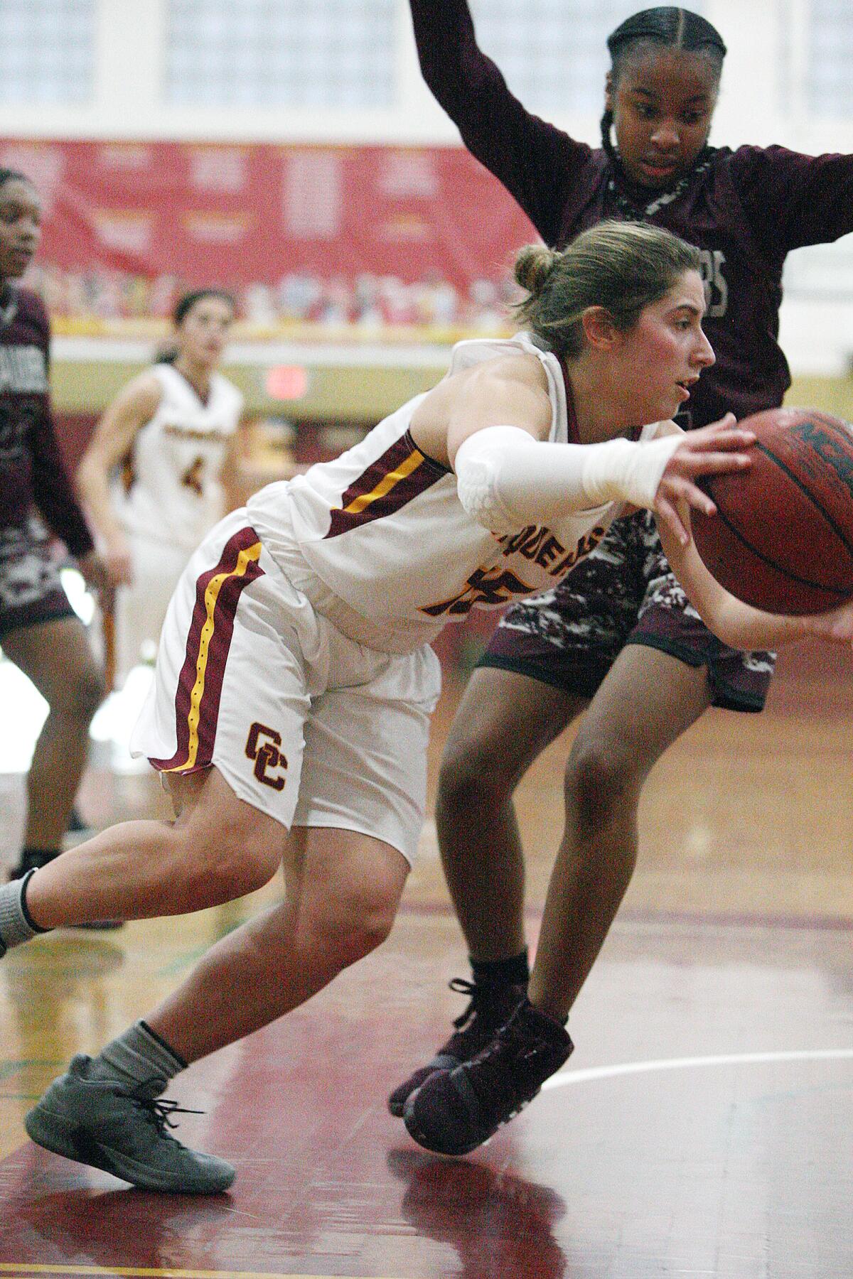 Glendale Community College's Gloria Bianchi drives under the basket defended by Antelope Valley's Malaiya Patton in a Western State Conference women's basketball game at Glendale Community College on Wednesday, January 22, 2020.