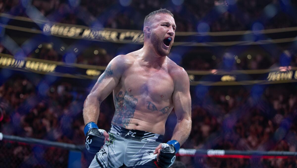 Justin Gaethje celebrates beating Dustin Poirier during their BMF title lightweight fight at UFC 291 on Saturday.