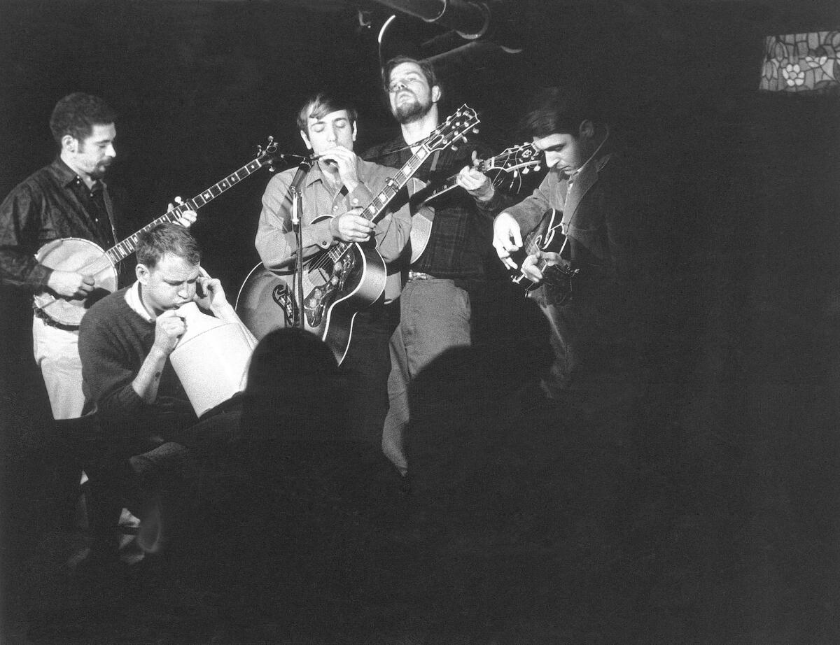 Samuel Charters plays the jug with folk legend Dave Van Ronk's band in 1963 in New York City. Charters, a music producer and writer on music history, died Wednesday at 85.