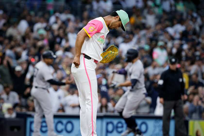 Padres starting pitcher Yu Darvish looks at the mound as Giancarlo Stanton rounds third base following his home run
