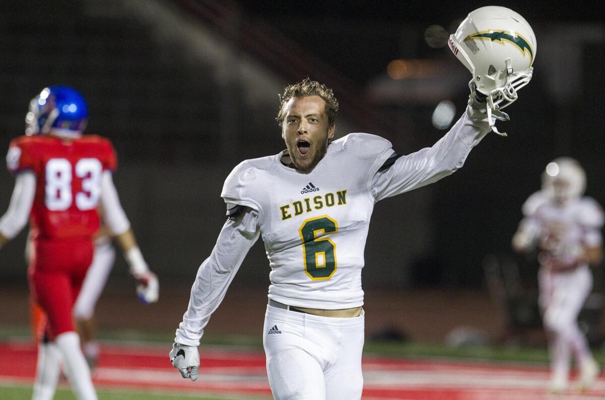 Edison High’s Nick Warren celebrates after Los Alamitos was stopped on four down on its final possession of the game.