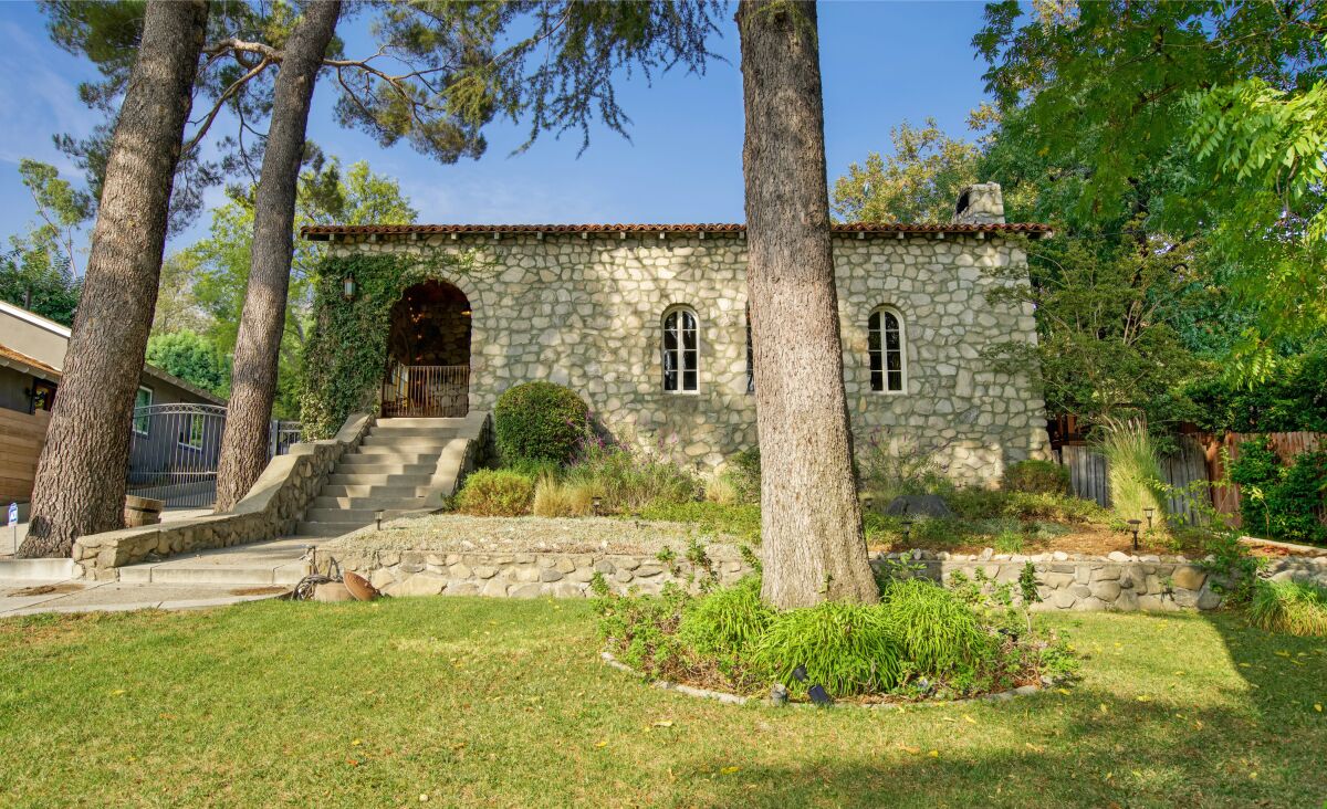 Built in 1936, the charming stone-clad home holds four bedrooms and five bathrooms in 2,800 square feet.
