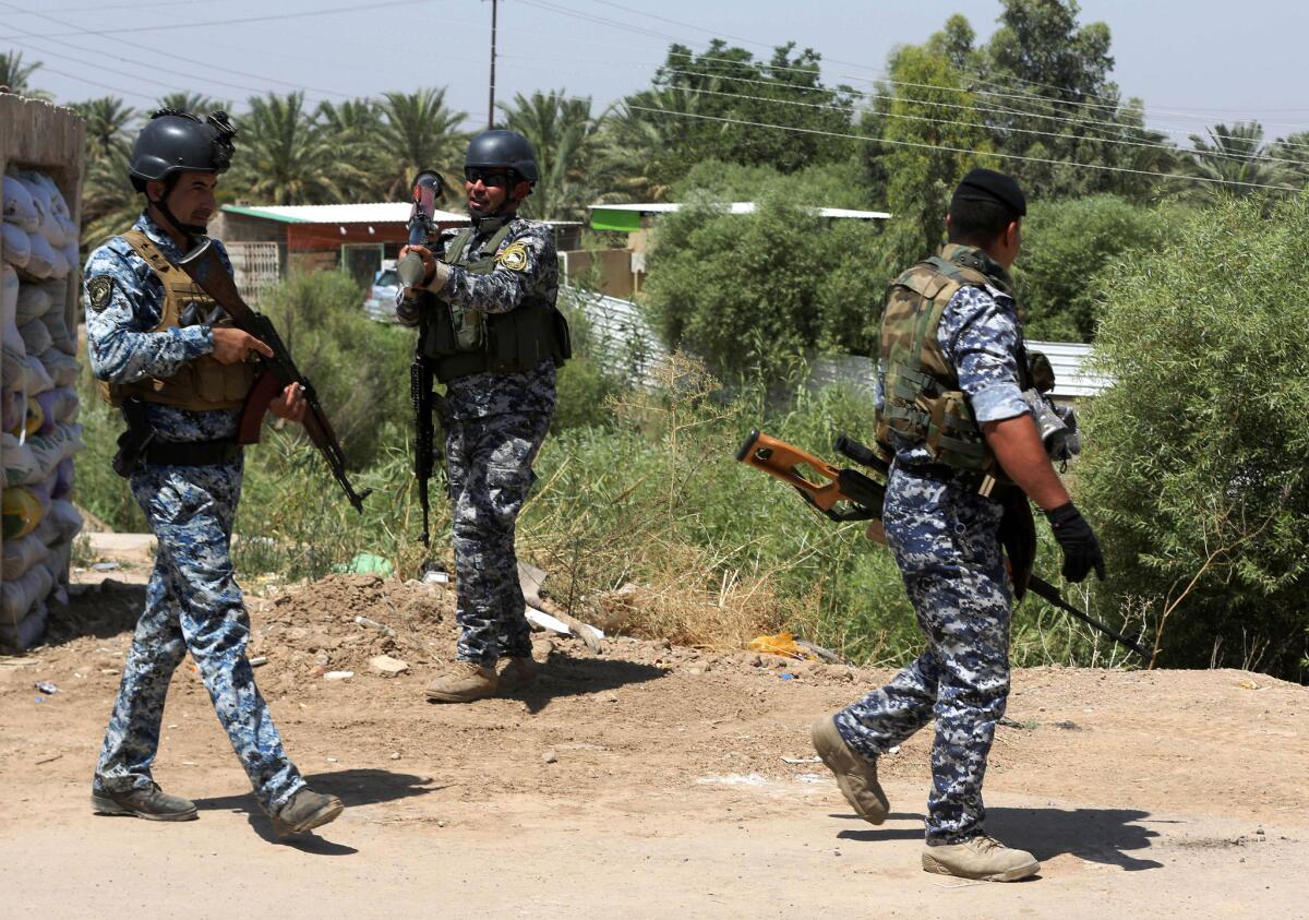 Iraqi federal policemen patrol in the town of Taji, north of Baghdad, the capital.