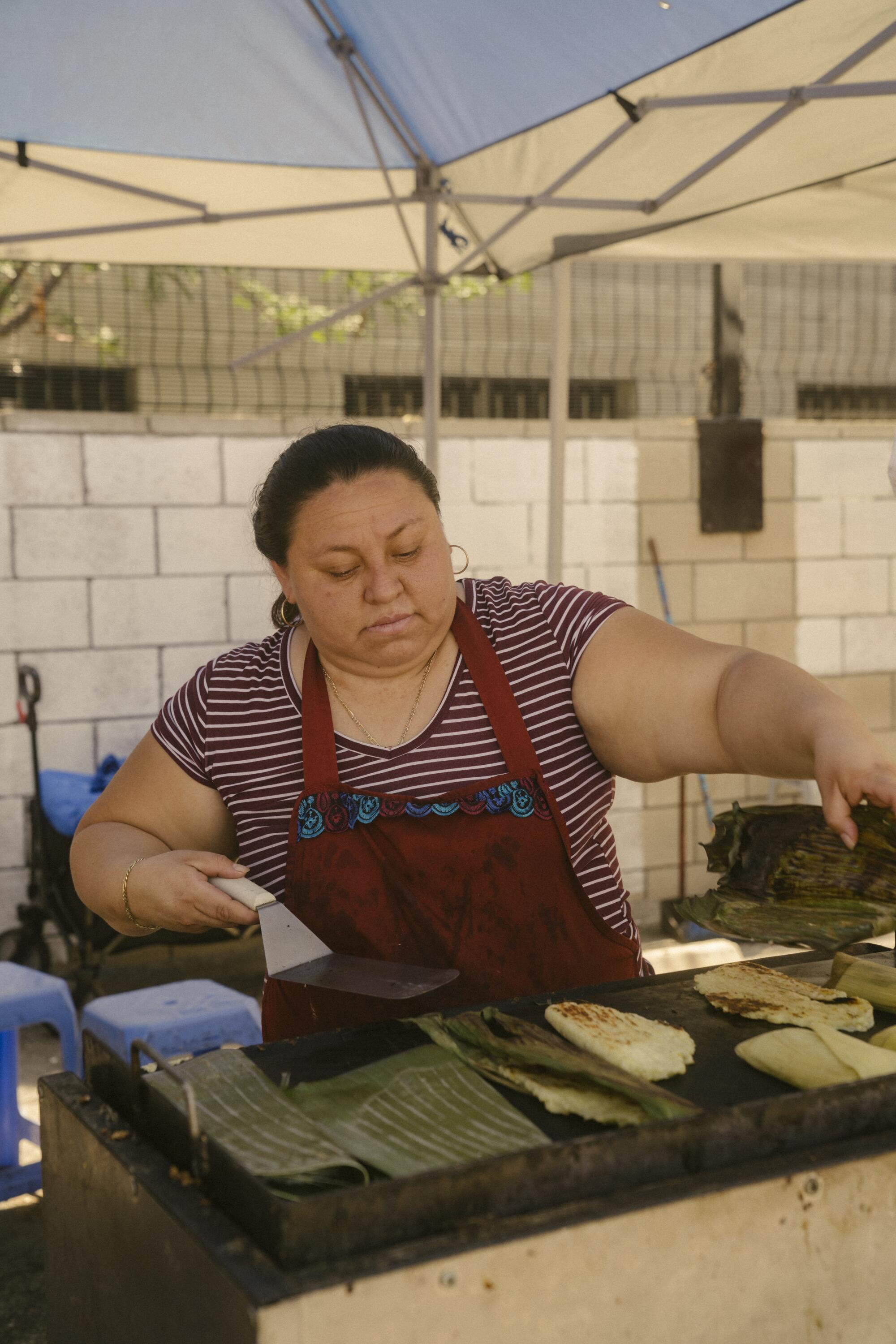 Maricela Serrano, who has also set up shop in the new location, prepares "riguas."