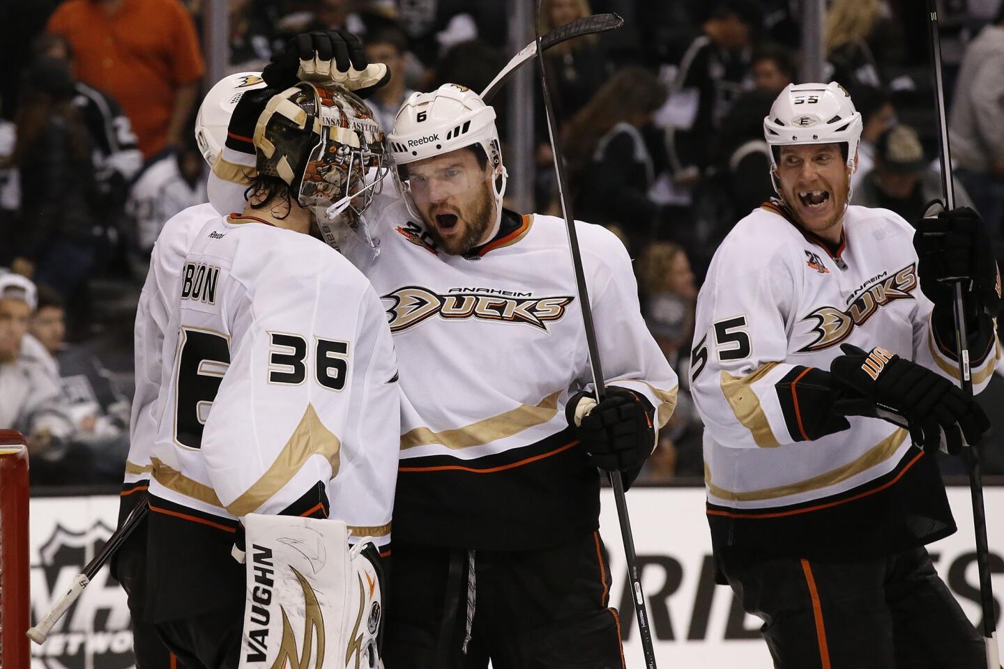 Ducks defensemen Ben Lovejoy and Bryan Allen (55) congratulate rookie goaltender John Gibson (36) after he shut out the Kings in Game 4 of their playoff series on Saturday night at Staples Center.