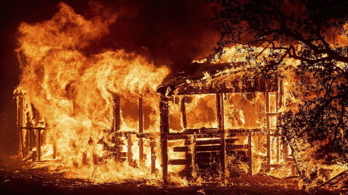 A structure burns as the Carr fire near Redding.