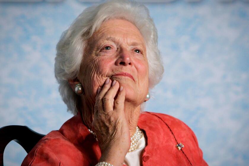 In this file photo from Friday, March 18, 2005, former first lady Barbara Bush listens to her son, President George W. Bush, as he speaks on Social Security reform in Orlando, Fla. The wife of former President George H.W. Bush is in "failing health," a Bush family spokesman said Sunday, April 15, 2018, following a recent series of hospitalizations and after consulting with her family and doctors, the 92-year-old former first lady has decided not to seek additional medical treatment and will instead focus on comfort care. (AP Photo/J. Scott Applewhite, file)