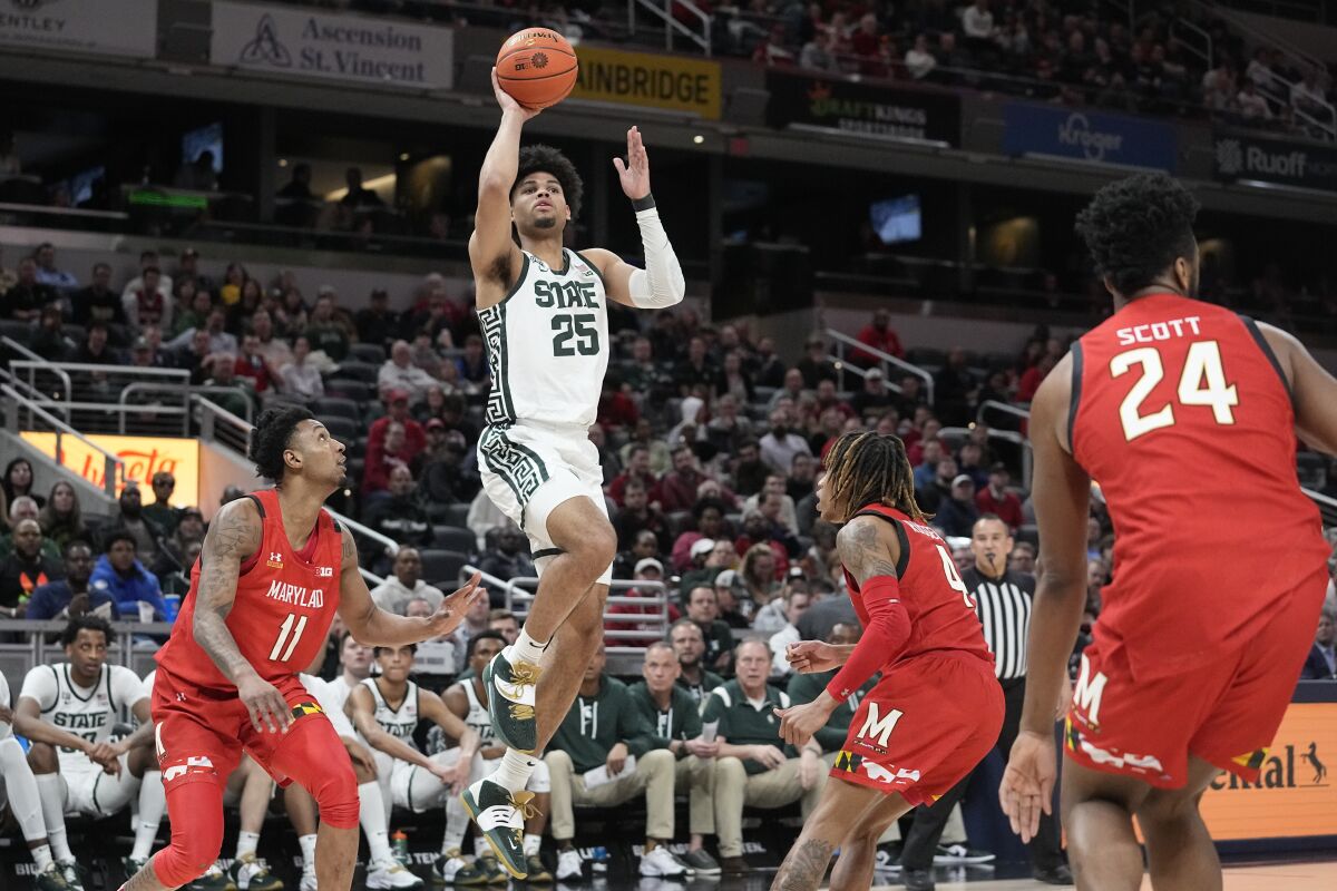 Michigan State's Malik Hall (25) puts up a shot against Maryland's Xavier Green and Fatts Russell (4) during the second half of an NCAA college basketball game at the Big Ten Conference tournament, Thursday, March 10, 2022, in Indianapolis. (AP Photo/Darron Cummings)