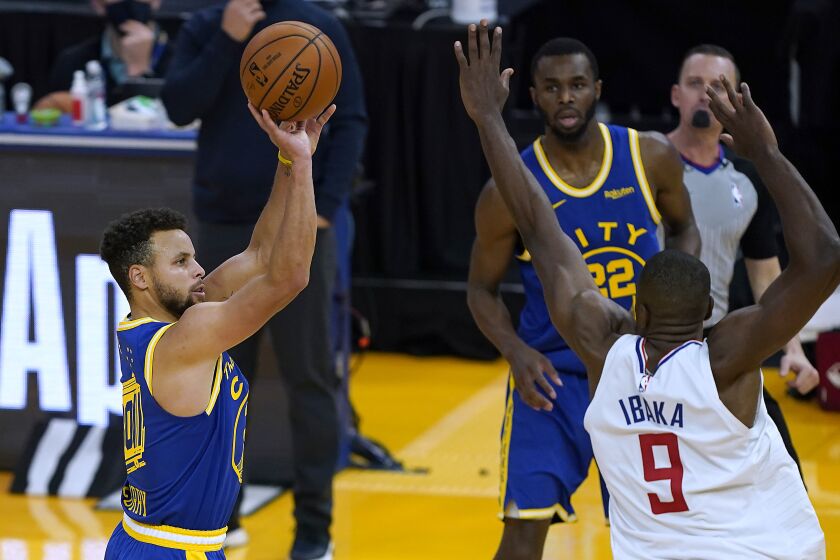 Golden State's Stephen Curry takes a three-point shot over the Clippers' Serge Ibaka on Jan. 8, 2021.