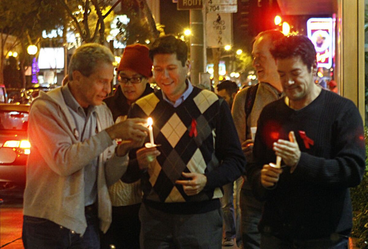 Ed Buck, left, gathers with Hernan Molina and West Hollywood Councilman John Duran at a candlelight vigil in West Hollywood in December 2010.